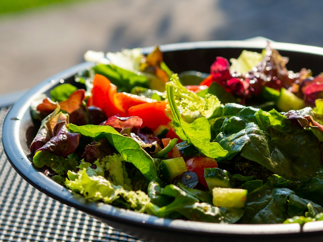 A vibrant low-sugar salad with greens, avocado, and grilled chicken